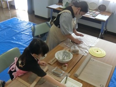 親子それぞれで粘土を伸ばしている