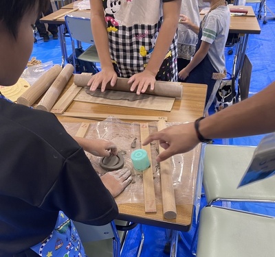 子どもが器の裏に付ける高台の型抜きをしている様子。